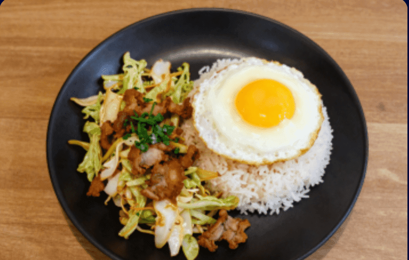 Stir-fried Cabbage with Fish Sauce over Rice with Crispy Pork