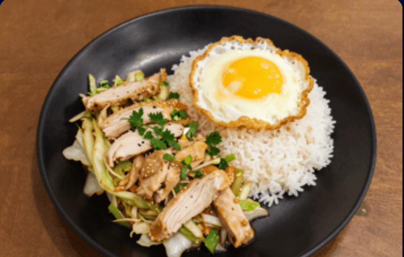 Stir-fried Cabbage with Fish Sauce over Rice with Sliced Chicken